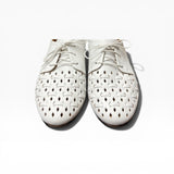 White perforated shoes on a white background