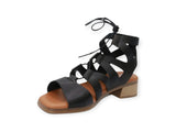 Black Eric Michael Roxanne sandals featuring a sleek strap design and open toe, displayed on a white background.
