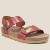 Red sandal with gold accents on a beige background