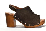 Brown suede clog shoe with wooden heel and studded details on a white background