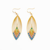 Gold earrings with colorful beads on a white background