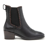 Black leather ankle boot with brown stitching on a white background