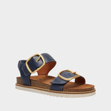 Navy blue sandal with gold buckles on a white background