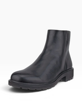 A single black leather ankle boot with a chunky lug sole and block heel, photographed from a three-quarters angle on a light gray background.