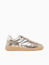 Gold metallic sneaker with white sole on a white background