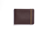 Carré Royal leather wallet in burgundy with minimalist design and sleek front, showcasing high-quality craftsmanship.
