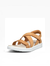 Tan sandal with criss-cross straps on a white background