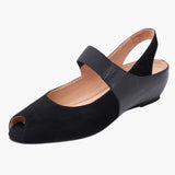 Black open-toe shoe with a strap on a white background