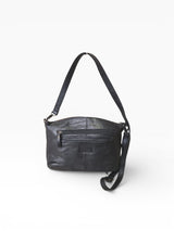 Black leather crossbody bag in front of a white backdrop