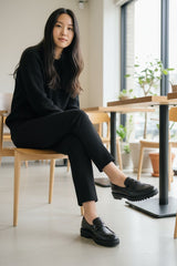 Strada black leather loafer with moccasin top and lug sole. Classic penny loafer style with a modern chunky heel.