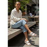 Strada white leather slide sandals with twin gold buckles and a platform wedge sole featuring Activ-Air Technology.