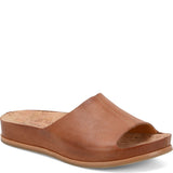 Kork Ease Tutsi Sandal for women, featuring stylish design and comfortable straps, shown in a natural outdoor setting.