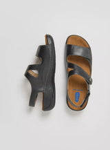 Black leather Wolky Liana 315 ultra-light sandal with open toe and adjustable strap, designed for comfort and style.